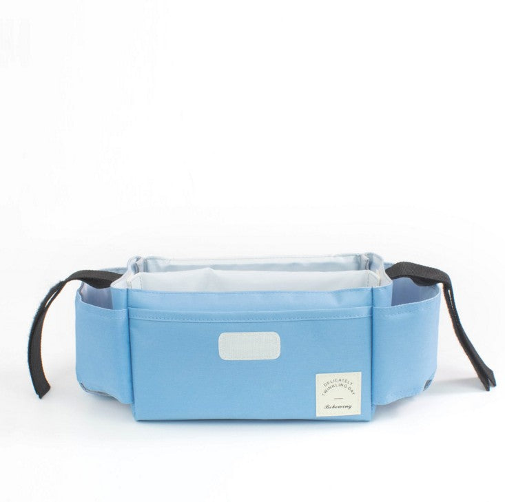 Blue stroller organiser bag with side pockets and velcro strap closure on a white background