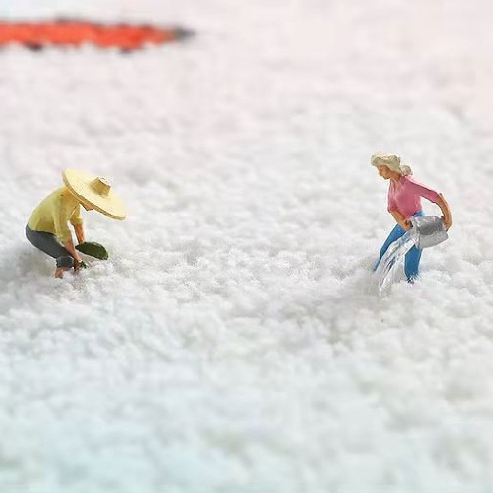 Close-up of the rug's soft plush texture with miniature figurines for scale