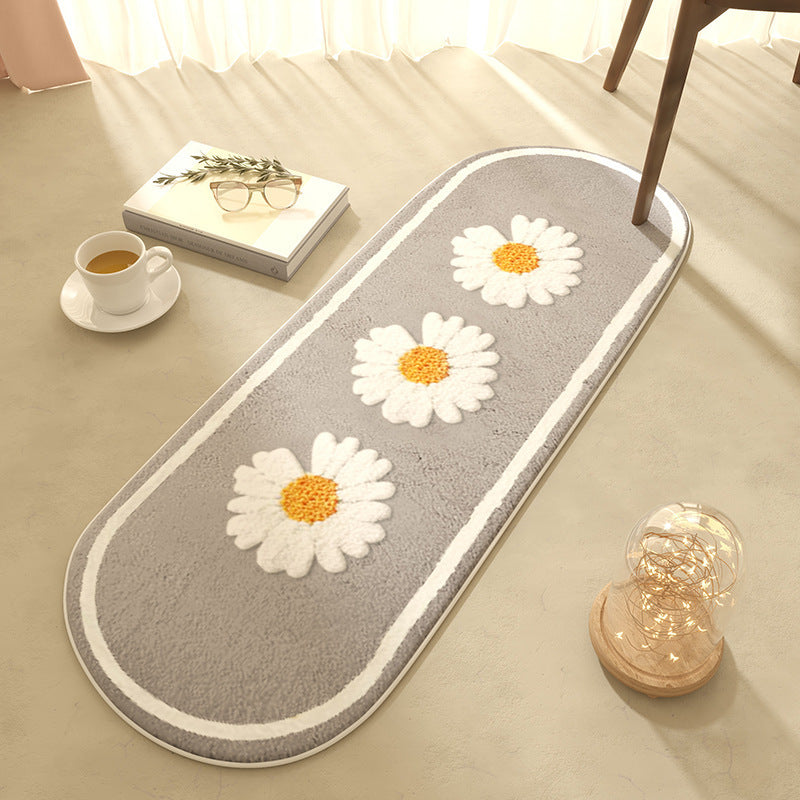 Oval bedroom rug with white daisy pattern on a gray background styled with a coffee cup