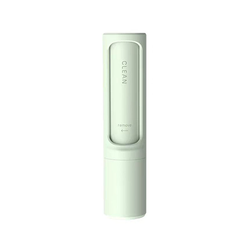 Mint green reusable pet hair remover brush shown with the clean-and-remove sliding mechanism