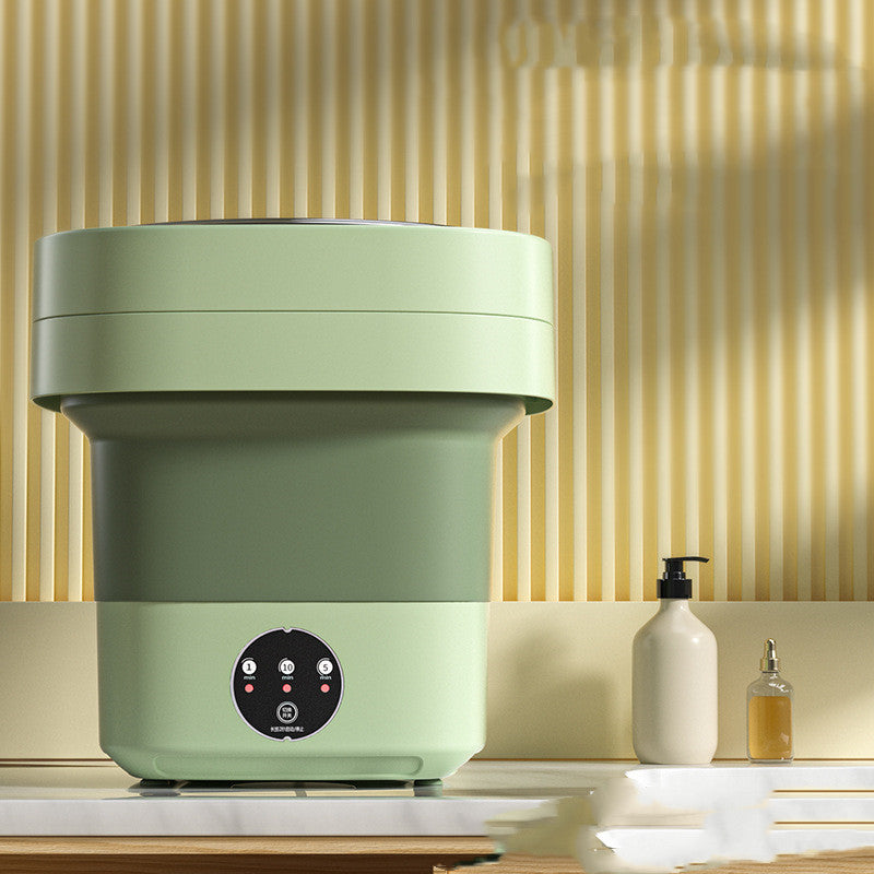 Close-up of the green washing machine with its 1, 5 and 10 minute timer buttons visible on the front panel