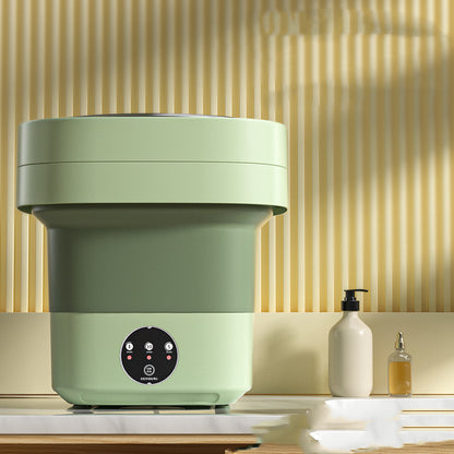 Close-up of the green washing machine with its 1, 5 and 10 minute timer buttons visible on the front panel