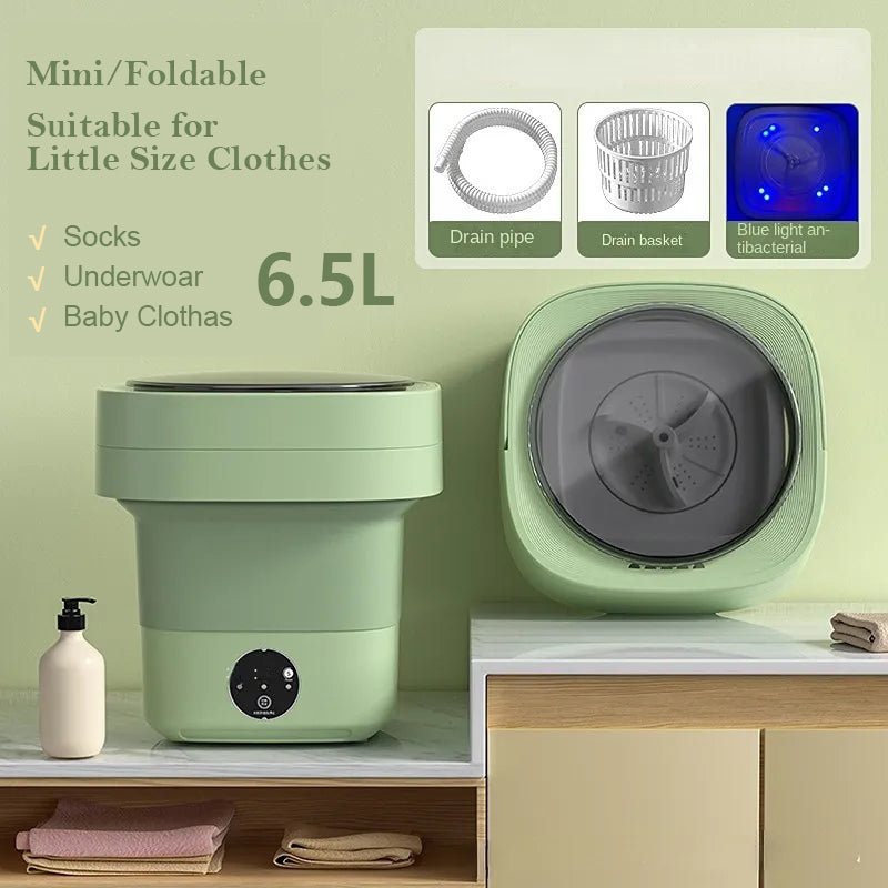 Sage green mini foldable washing machine shown folded and open, with drain pipe, drain basket and blue light drum, labelled 6.5L for socks, underwear and baby clothes