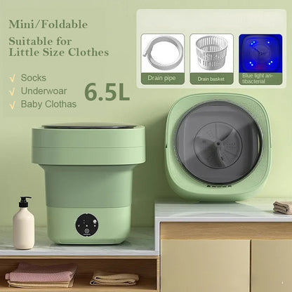 Sage green mini foldable washing machine shown folded and open, with drain pipe, drain basket and blue light drum, labelled 6.5L for socks, underwear and baby clothes