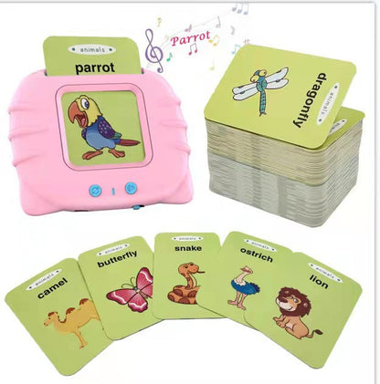 Pink talking flash card machine reading the word parrot aloud, with green animal cards for camel, butterfly, snake, ostrich and lion fanned out below