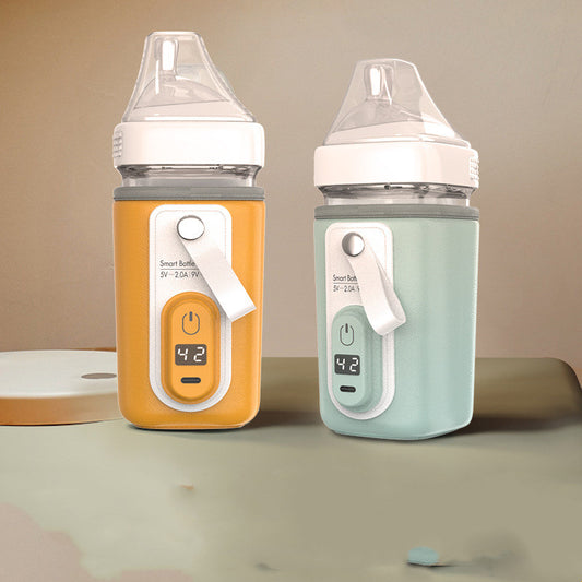 Yellow and green USB bottle warmer sleeves wrapped around baby bottles, each showing 42 degrees on the display