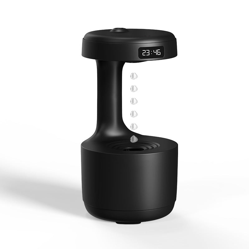 Black anti-gravity water drop humidifier with an LED clock display and a column of droplets suspended between the cap and base