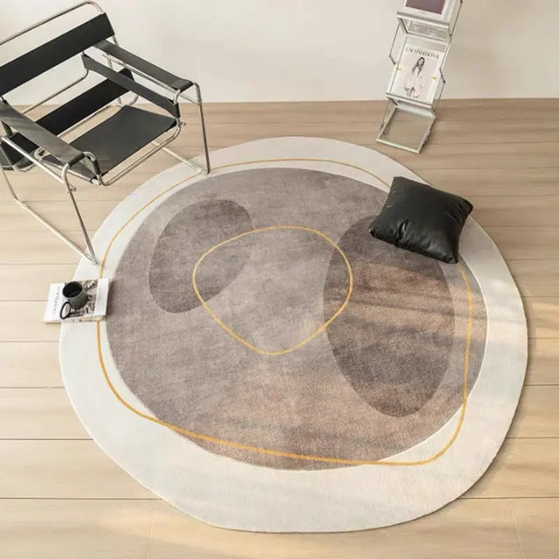 Cashmere-look round rug in gray and mauve colorway styled with a black pillow