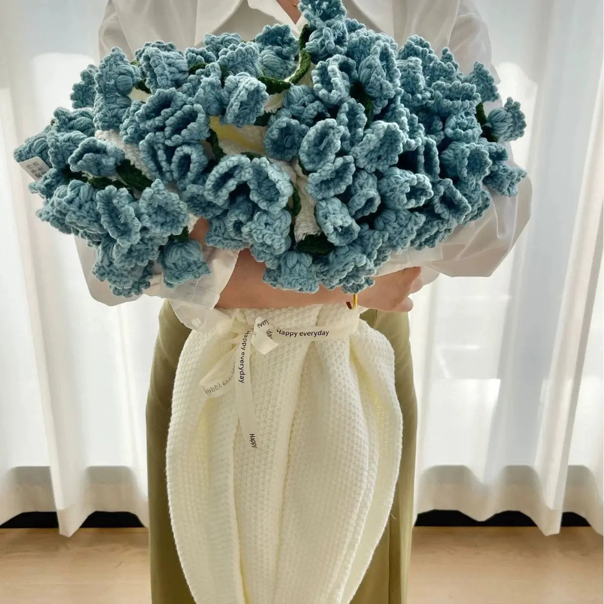 Floral woven cotton blanket folded into a blue flower bouquet design