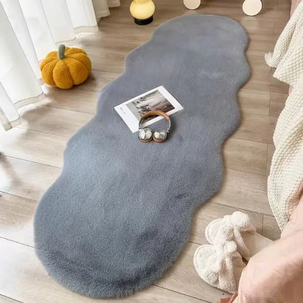 Area rug in gray colorway styled in a cozy bedroom setting