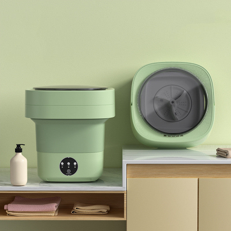 Green foldable washing machine open beside a second unit turned to show the grey spin drum inside