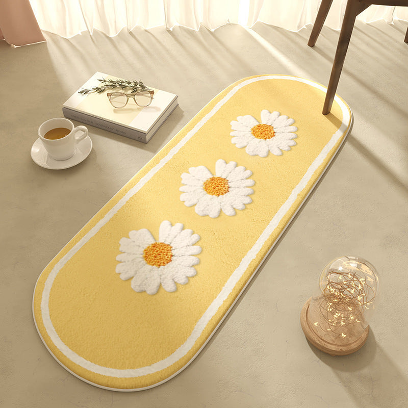 Oval bedroom rug with white daisy pattern on a yellow background styled with a coffee cup