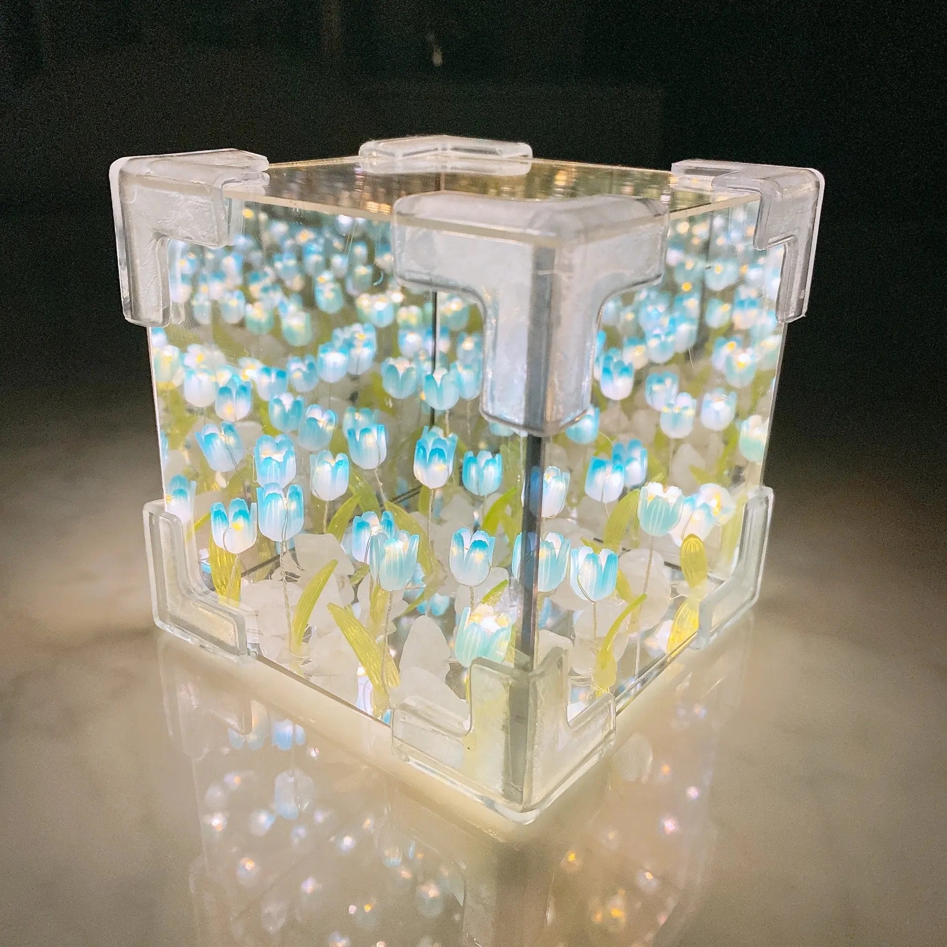 DIY tulip mirror night light kit assembled into a glowing blue cube lamp