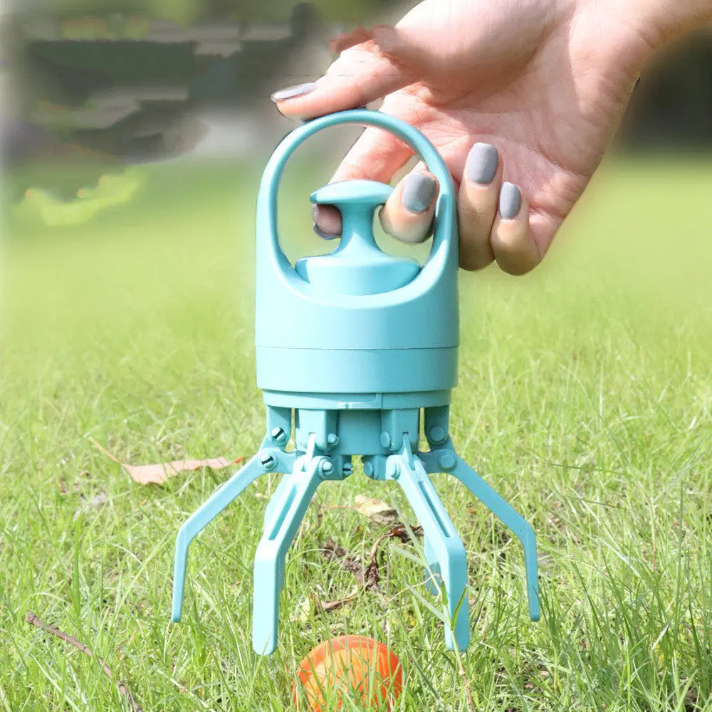 Hand holding the dog pooper scooper closeup over grass
