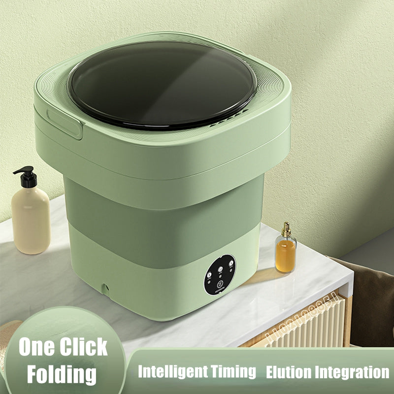 Green foldable washing machine open on a marble counter showing the three-button timer panel on the front