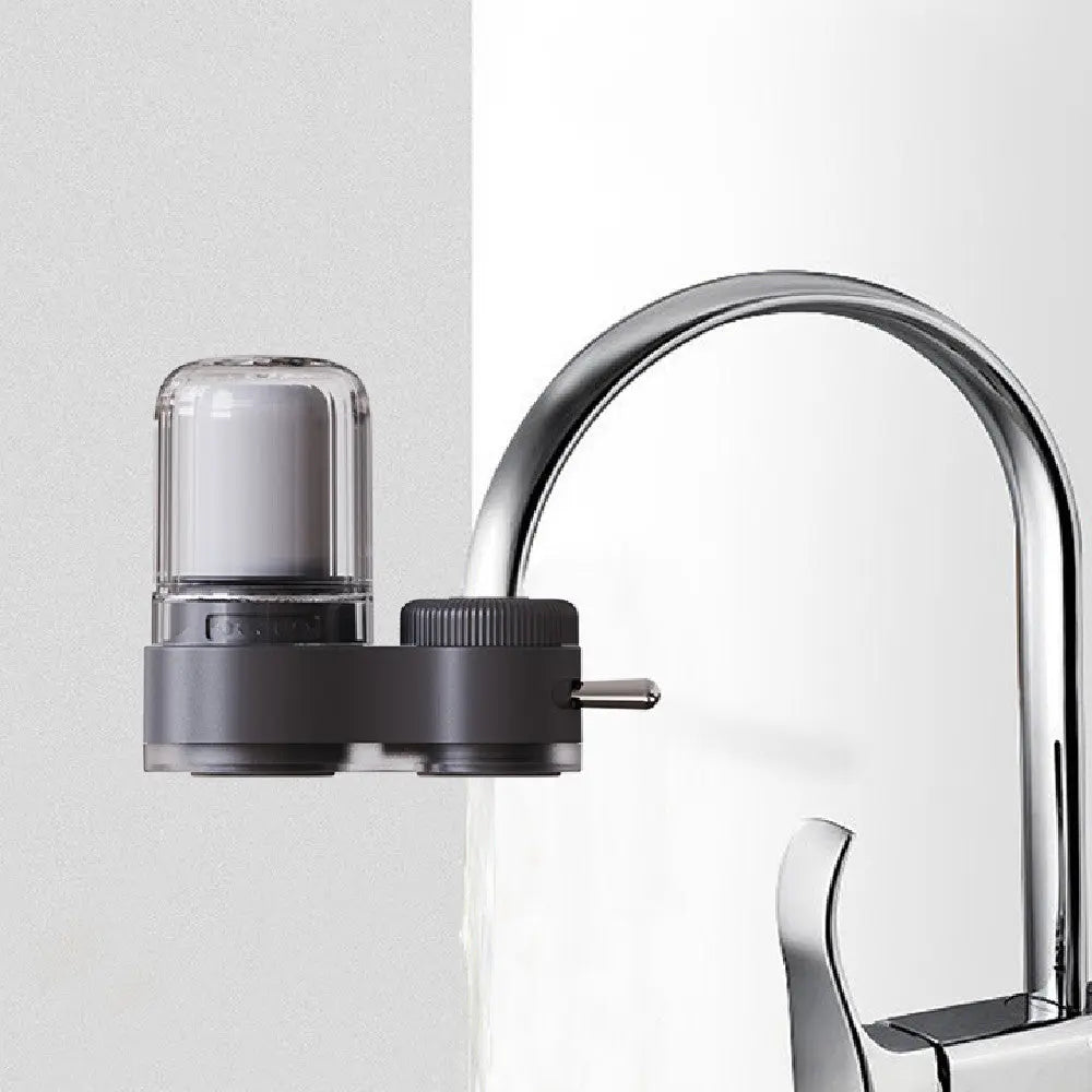 Faucet-mounted water purifier filter installed and in use on a kitchen tap