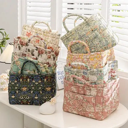 Floral cotton fabric storage baskets in multiple sizes and patterns styled on a table