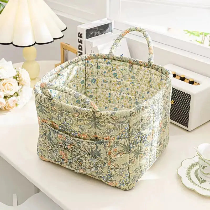 Close-up of the woven handle detail on the floral cotton storage basket