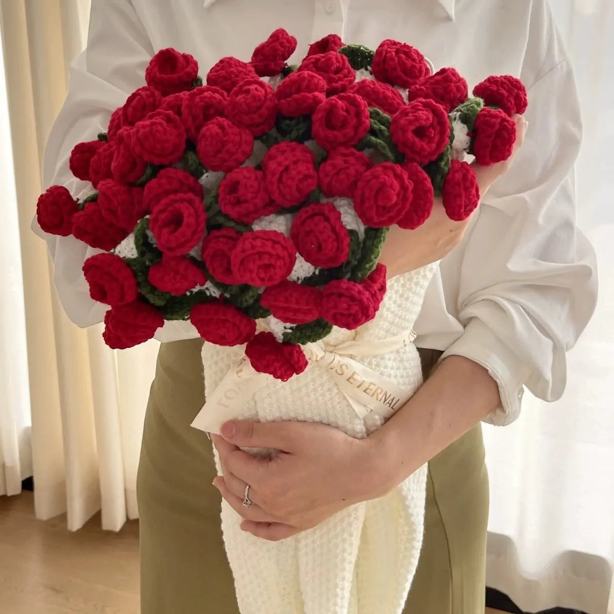 Floral woven cotton blanket folded into a red rose bouquet design