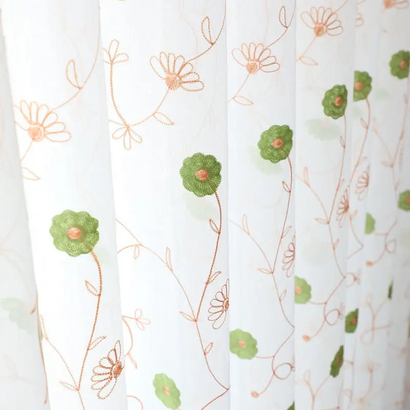 Garden embroidered sheer curtain hanging as a full window panel