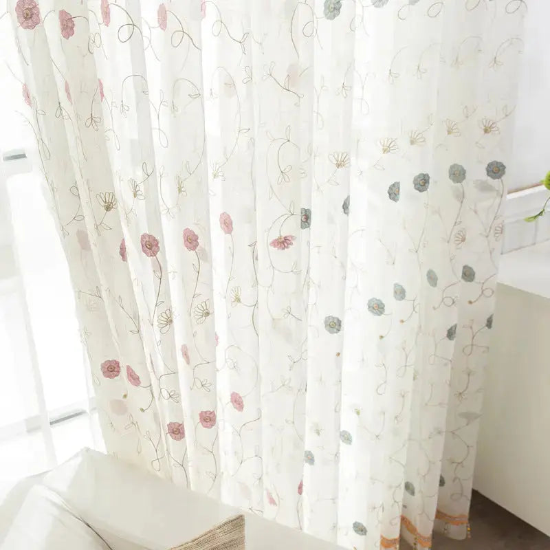 Garden embroidered sheer curtain panel with natural light filtering through