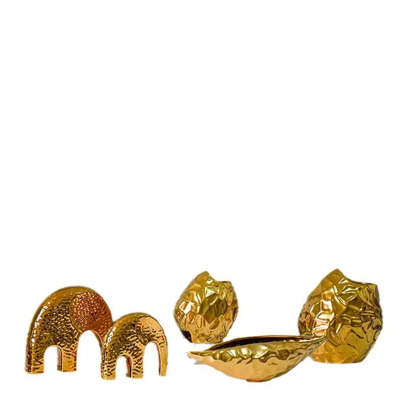 Close-up of the gold-plated ceramic bowl vase showing hammered texture