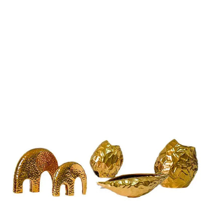 Close-up of the gold-plated ceramic bowl vase showing hammered texture