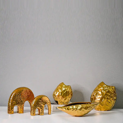 Gold-plated geometric ceramic vase in bowl shape on a white background