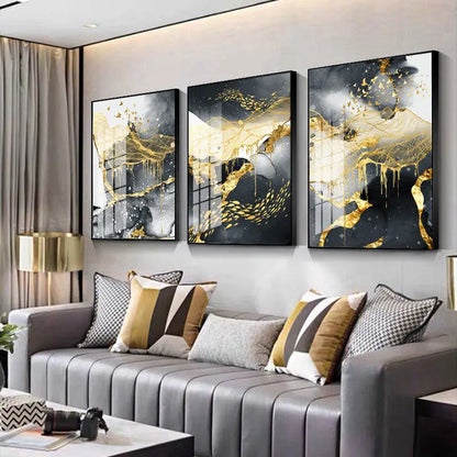 Gold, black, and white canvas wall art three-panel set displayed above a striped sofa