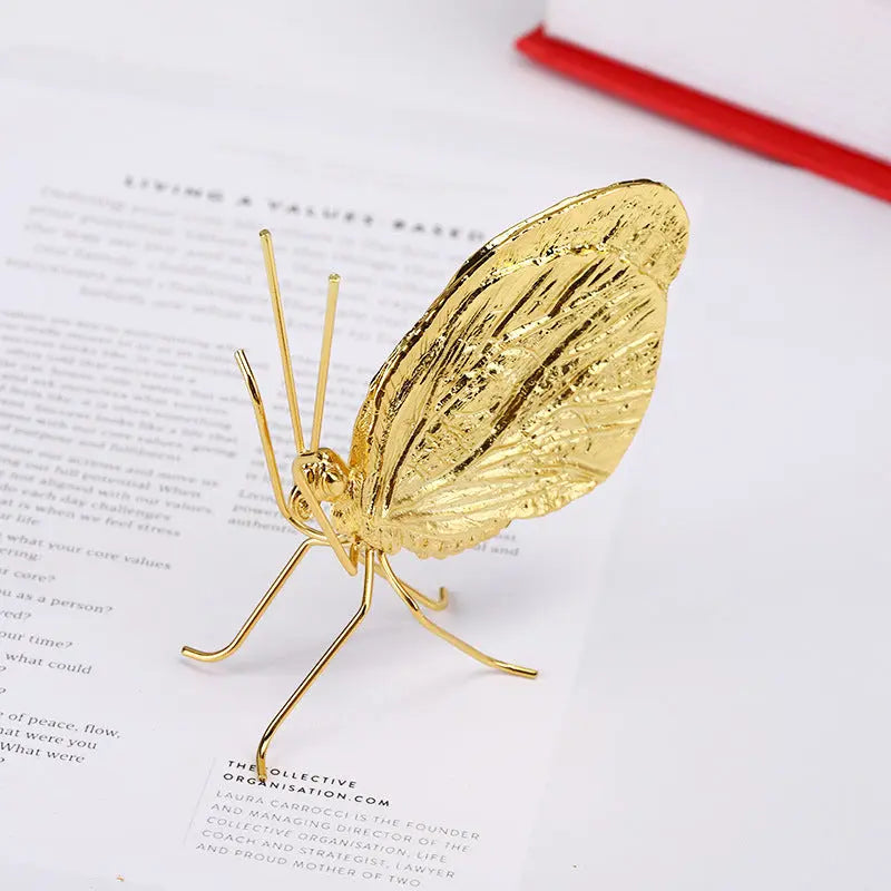 Close-up of the gold butterfly decorative ornament showing wing detail and finish