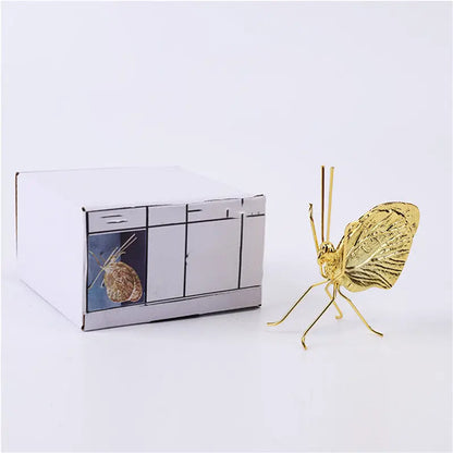 Gold butterfly decorative ornament styled on a shelf as a minimalist accent