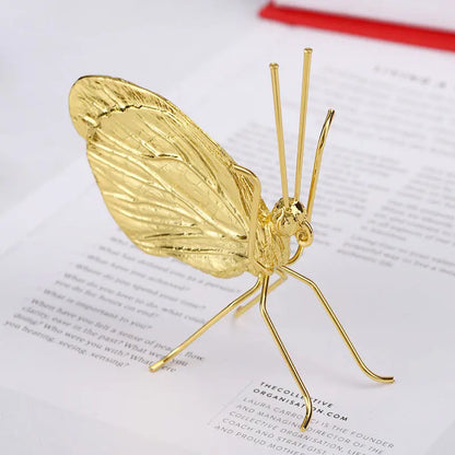 Gold butterfly decorative ornament shown with size dimensions
