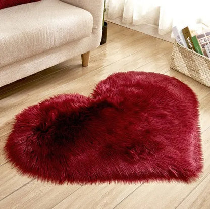 Red heart-shaped fluffy rug styled in a cozy bedroom setting
