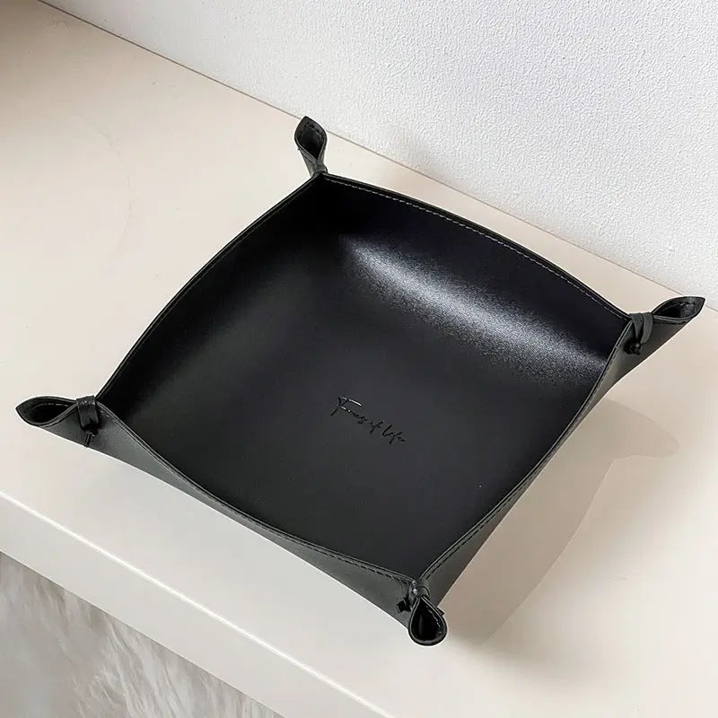 Leather storage tray in black colorway on a desk