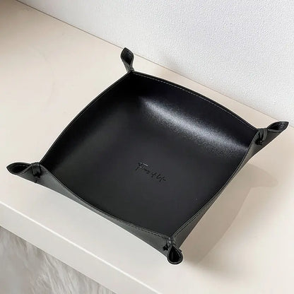 Leather storage tray in black colorway on a desk