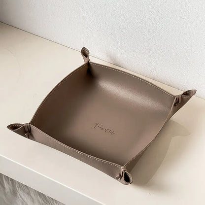Leather storage tray in brown colorway on a desk