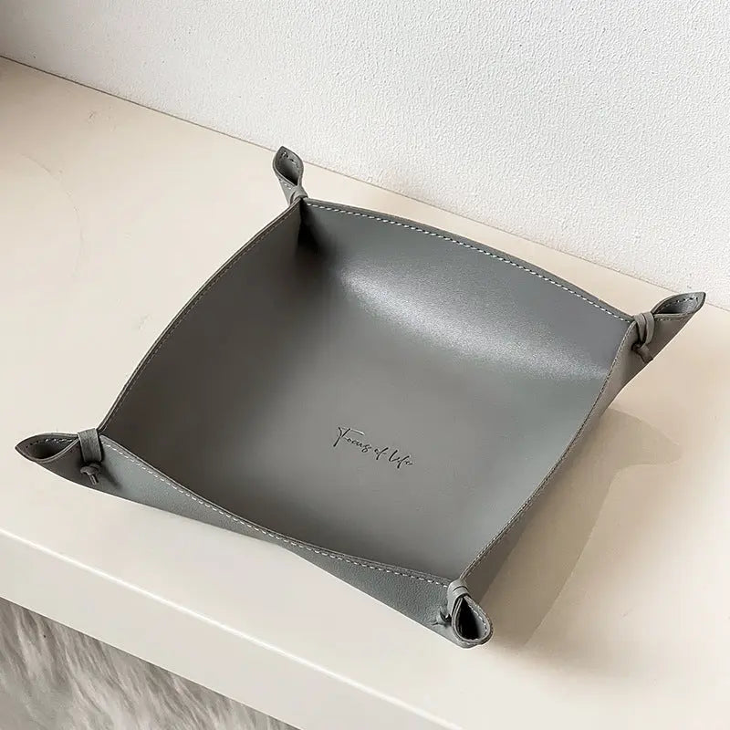 Leather storage tray in gray colorway on a desk