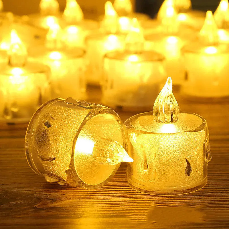 Dramatic close-up of LED flameless tea light candles glowing