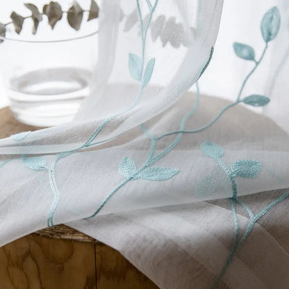 Close-up of the pastoral embroidery pattern on the sheer gauze curtain