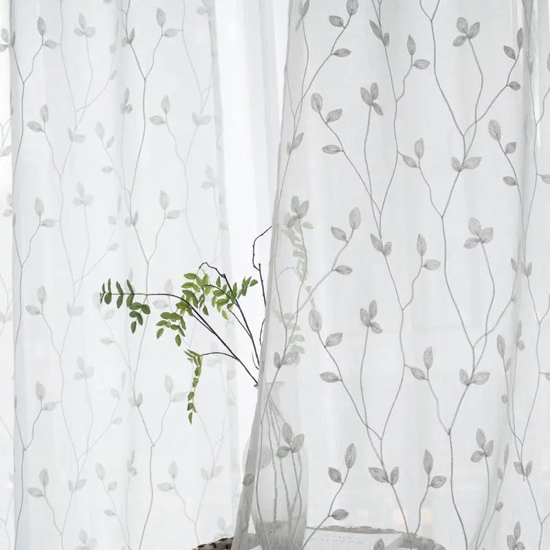 Pastoral embroidery gauze curtain in gray colorway styled in a room