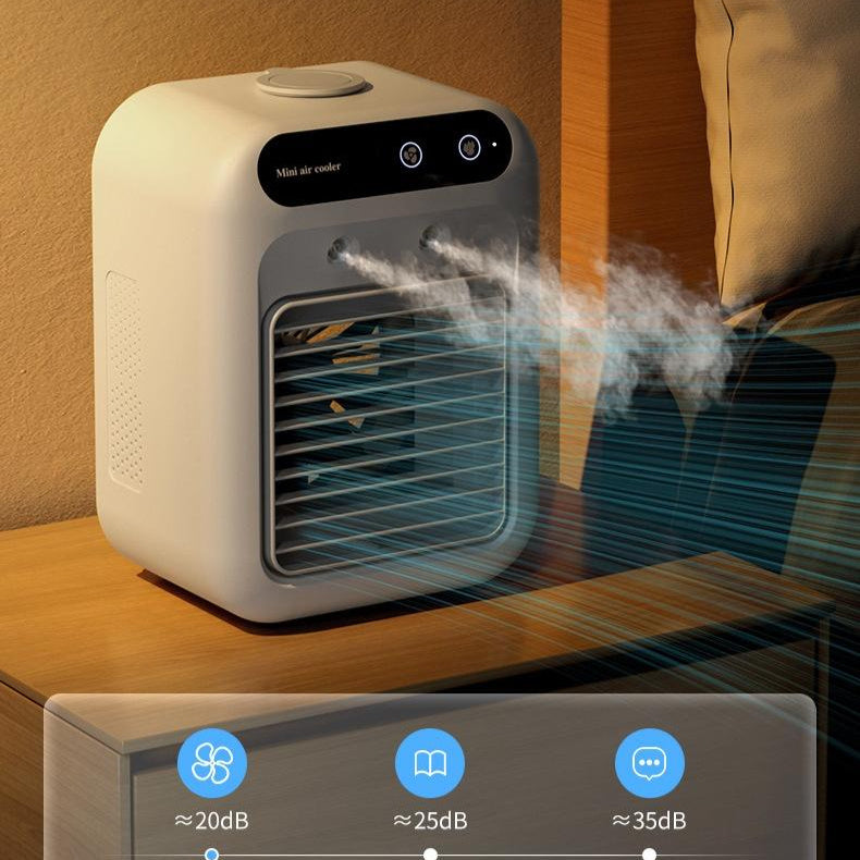 Portable USB air cooler fan misting beside a pillow on a nightstand with noise level icons