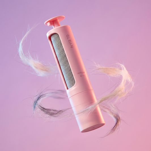 Reusable pet hair remover brush shown with a dynamic swirl of collected pet fur