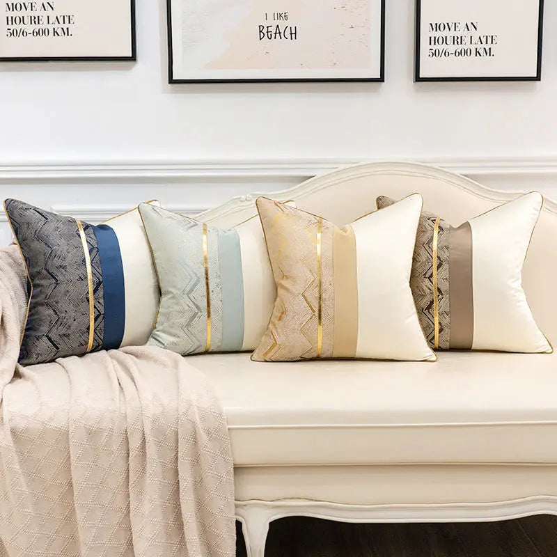 Satin splicing cushion covers in four color combinations styled together on a sofa
