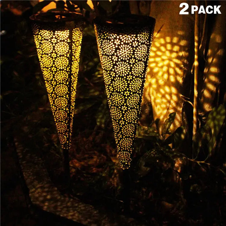 Solar garden projection light casting colorful patterns on the ground at night
