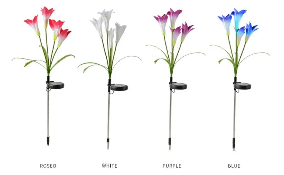 Multiple solar lily garden stake lights glowing in different colors in a garden at night