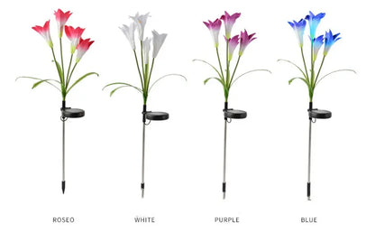 Multiple solar lily garden stake lights glowing in different colors in a garden at night