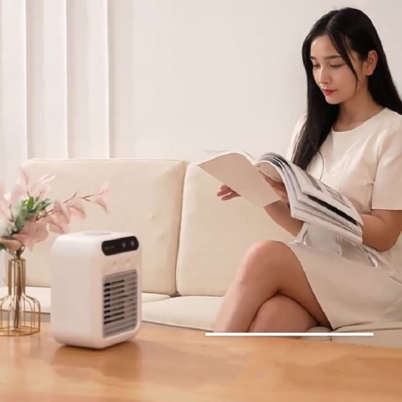 Portable USB air cooler fan used while reading on a couch