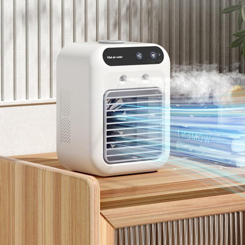 Portable USB air cooler fan misting on a wooden dresser with an outdoor patio backdrop