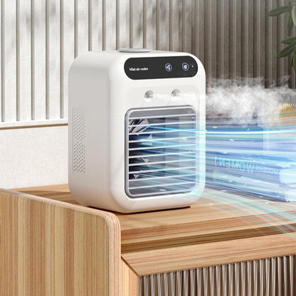 Portable USB air cooler fan misting on a wooden dresser with an outdoor patio backdrop