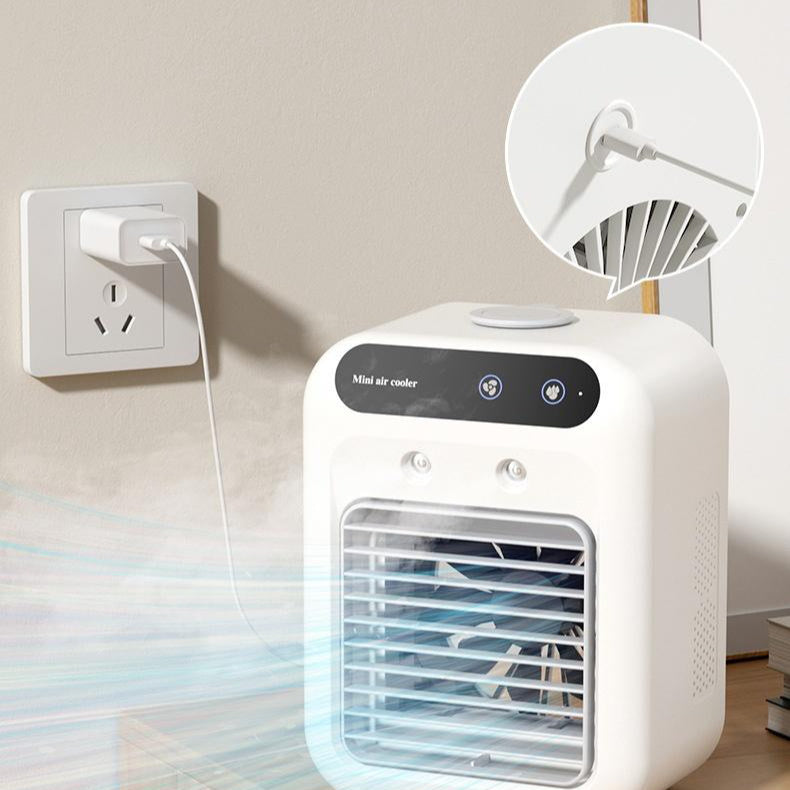 Portable USB air cooler fan plugged into an outlet with rotating fan blade detail